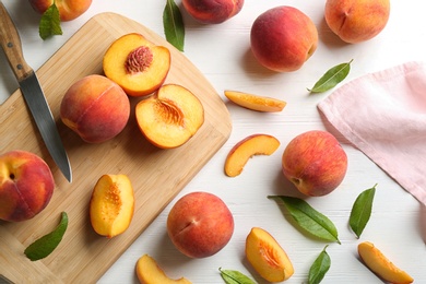Photo of Flat lay composition with fresh sweet peaches on white wooden table