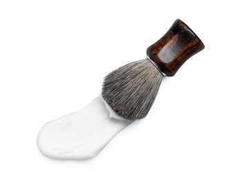 Shaving brush and foam on white background, top view