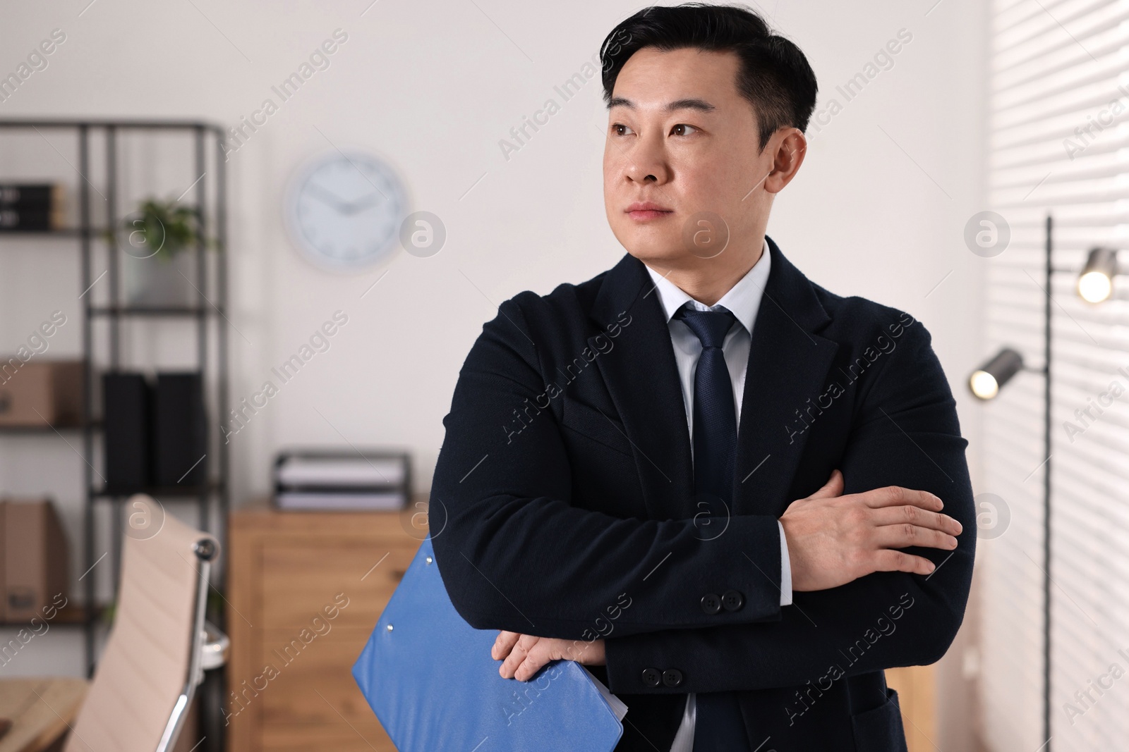 Photo of Portrait of confident notary with clipboard in office, space for text
