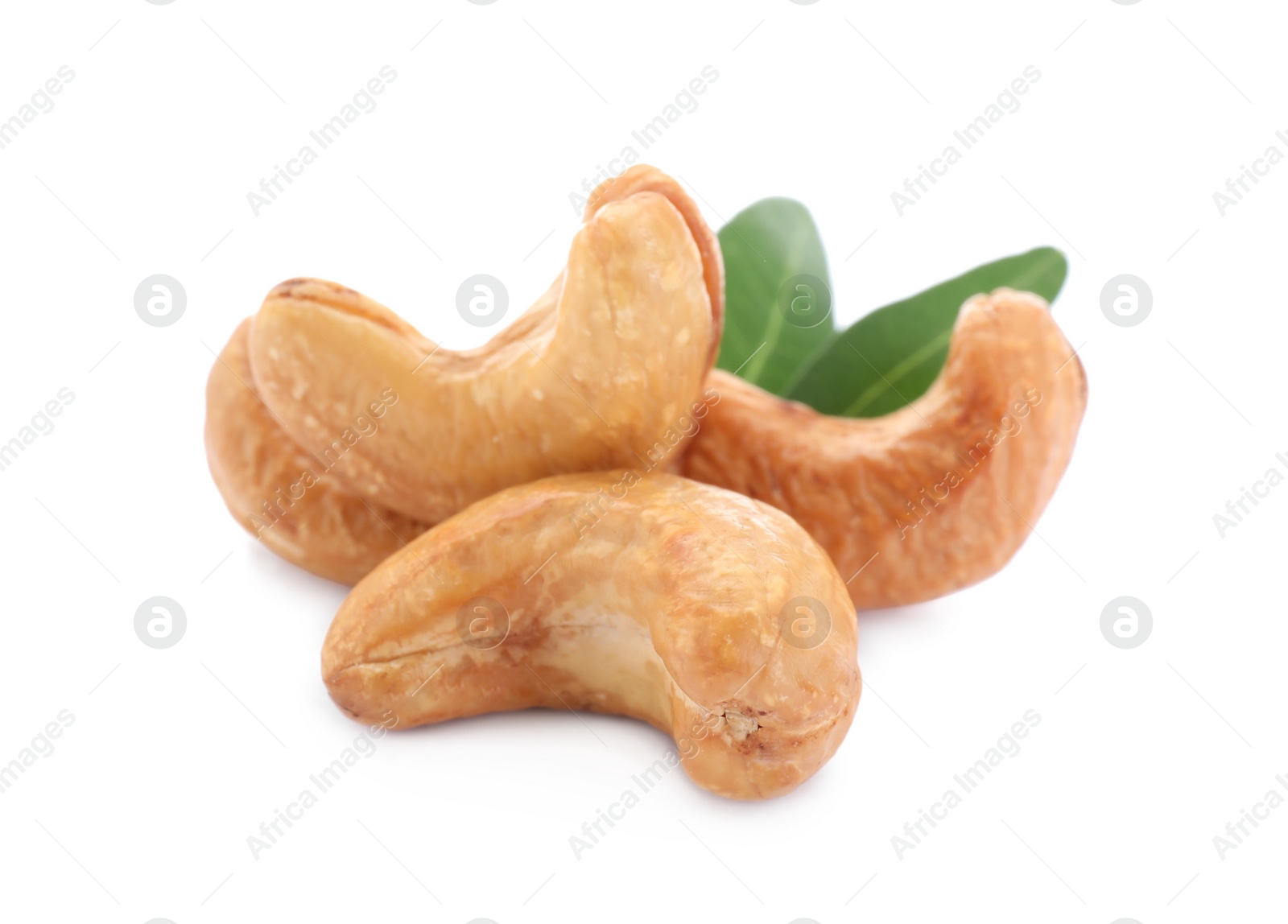 Photo of Tasty organic cashew nuts and green leaves isolated on white