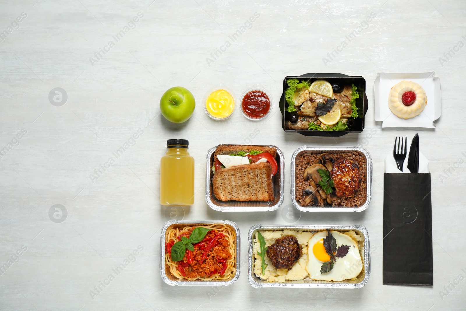 Photo of Lunchboxes on white wooden table, flat lay. Healthy food delivery