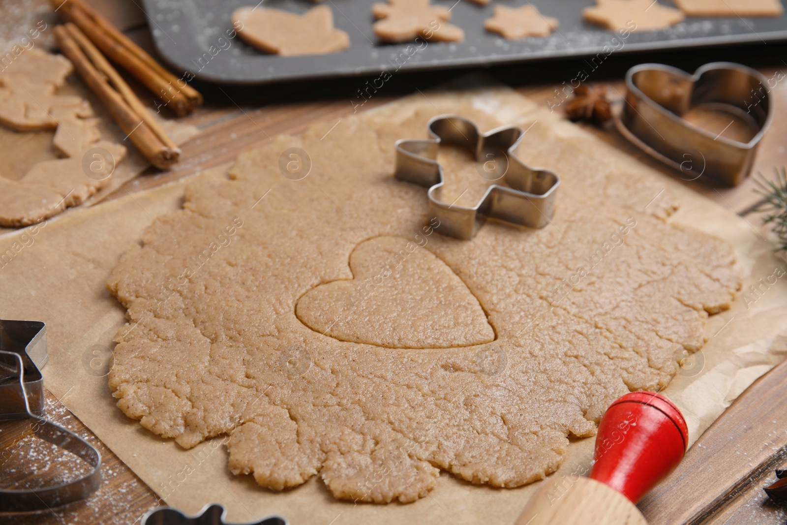 Photo of Homemade Christmas biscuits. Dough and cookie cutters on table