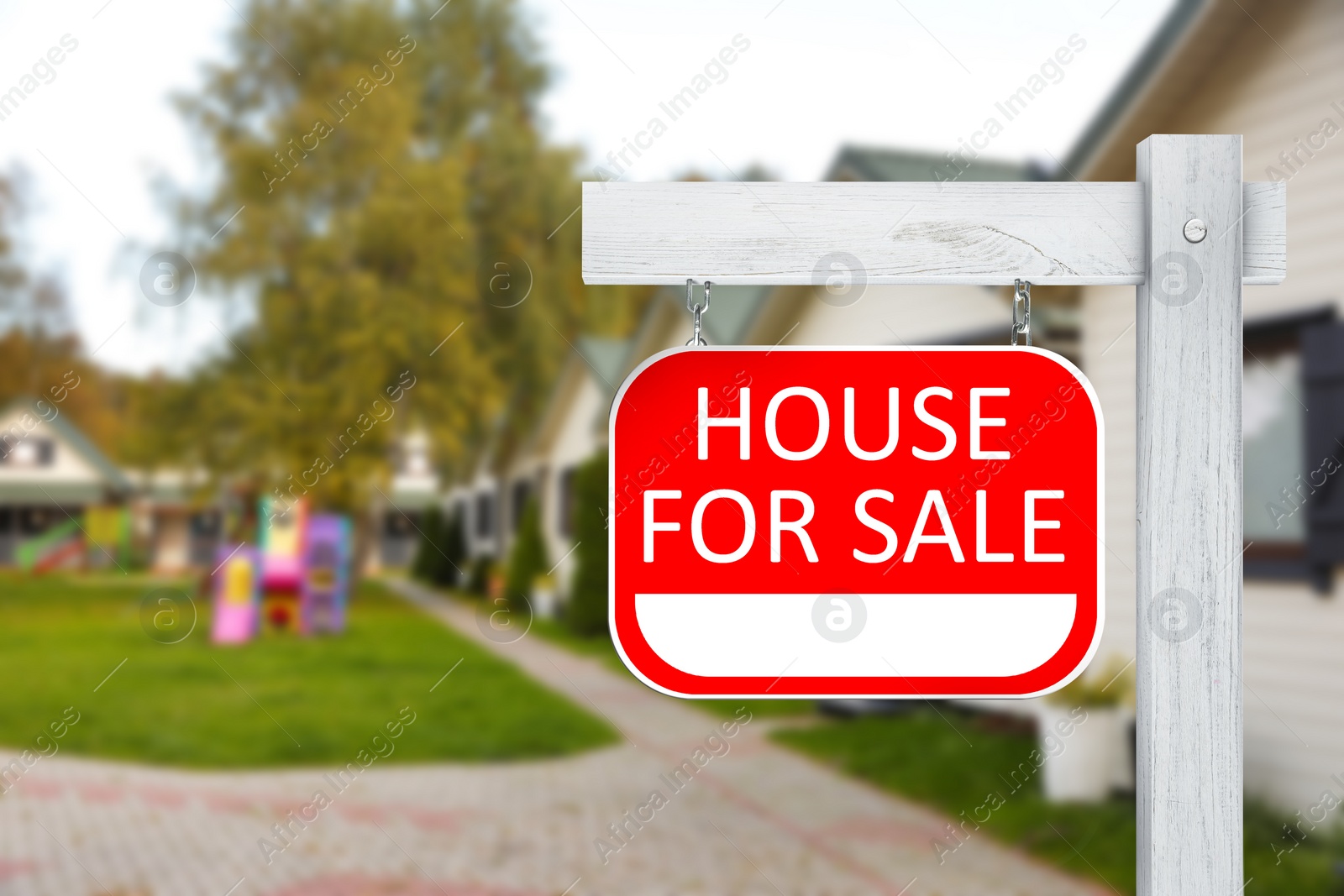 Image of Sale sign near beautiful house outdoors. Red signboard with words