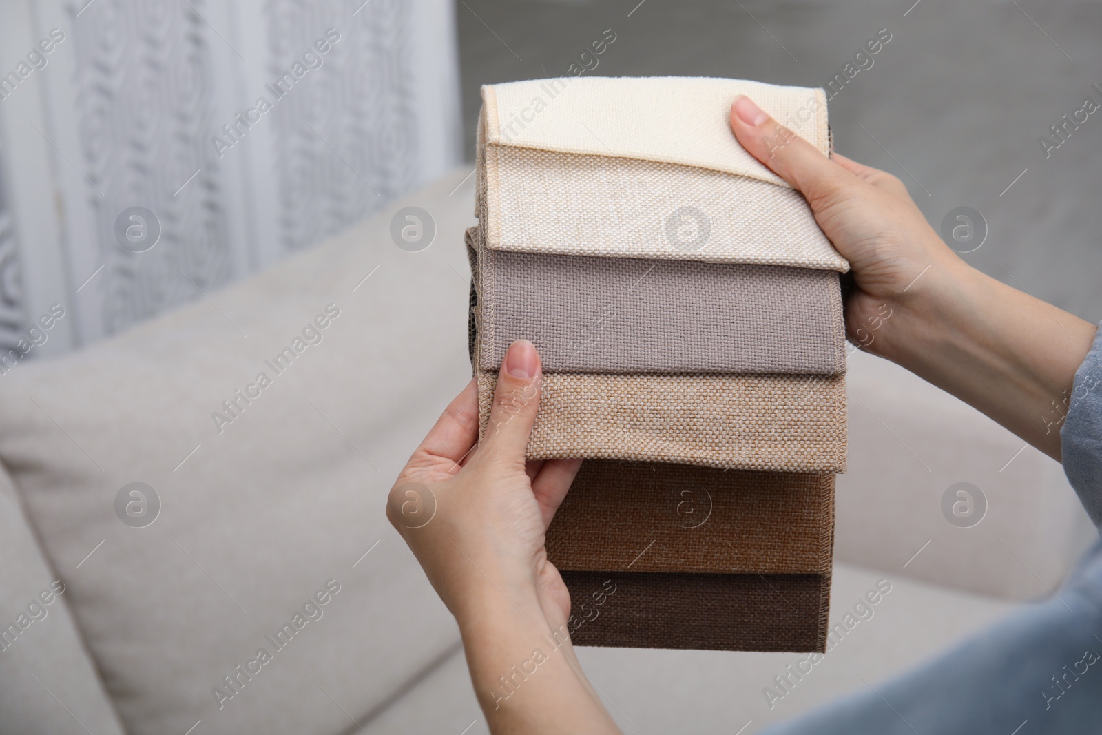 Photo of Woman choosing fabric among colorful samples at home, closeup. Space for text