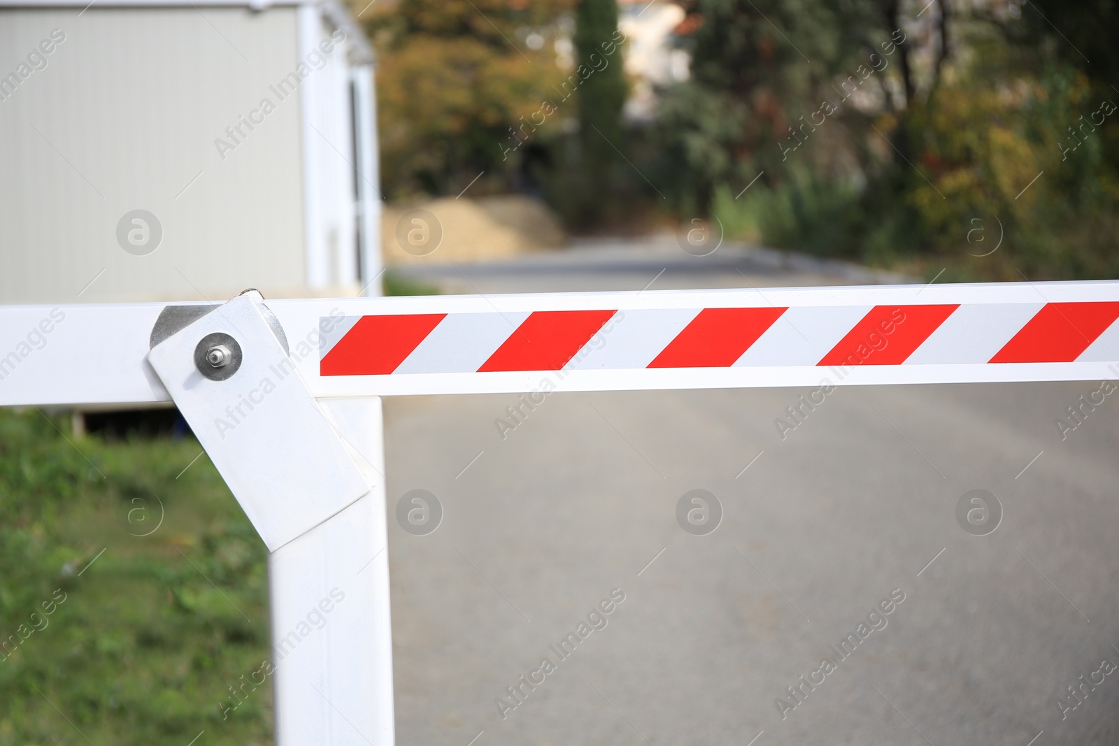 Photo of Closed boom barrier in city on sunny day, closeup