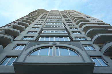 Low angle view of modern building against blue sky