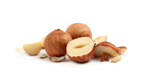 Photo of Heap of tasty hazelnuts on white background
