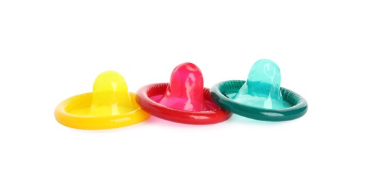 Unpacked colorful condoms on white background. Safe sex