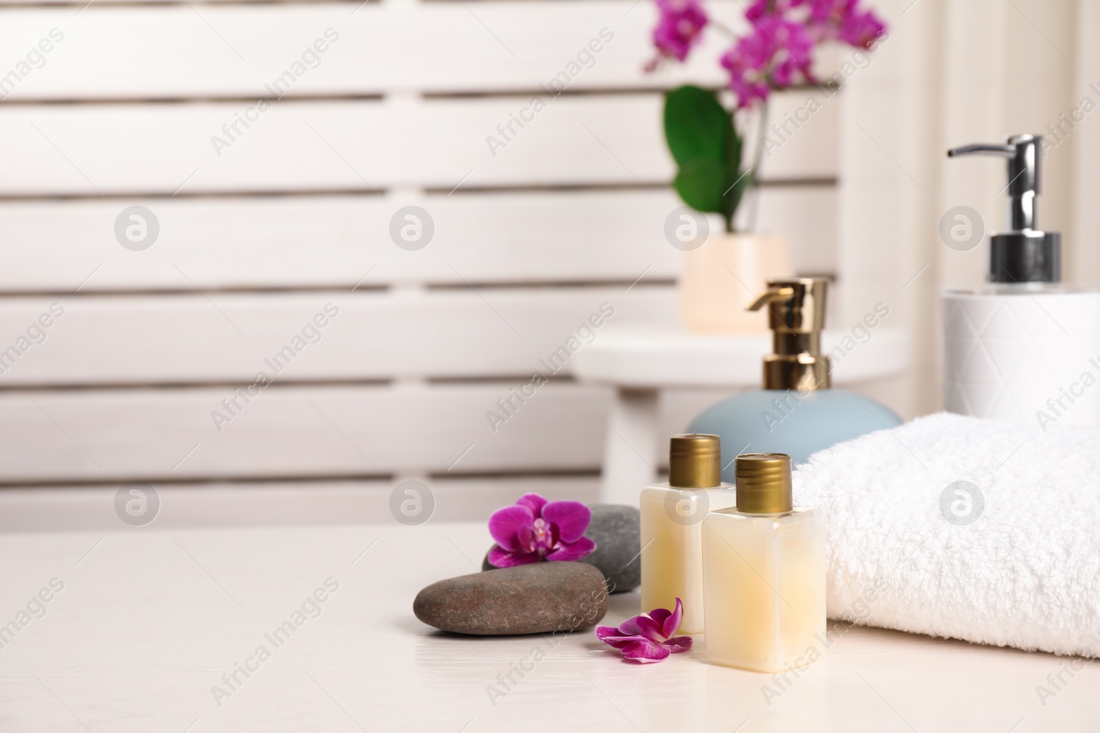 Photo of Composition with orchid flowers and spa accessories on table indoors. Space for text