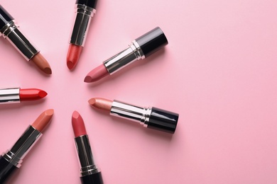 Photo of Flat lay composition with lipsticks and space for text on color background