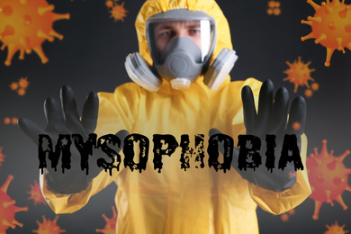 Image of Man in chemical protective suit against black background. Mysophobia