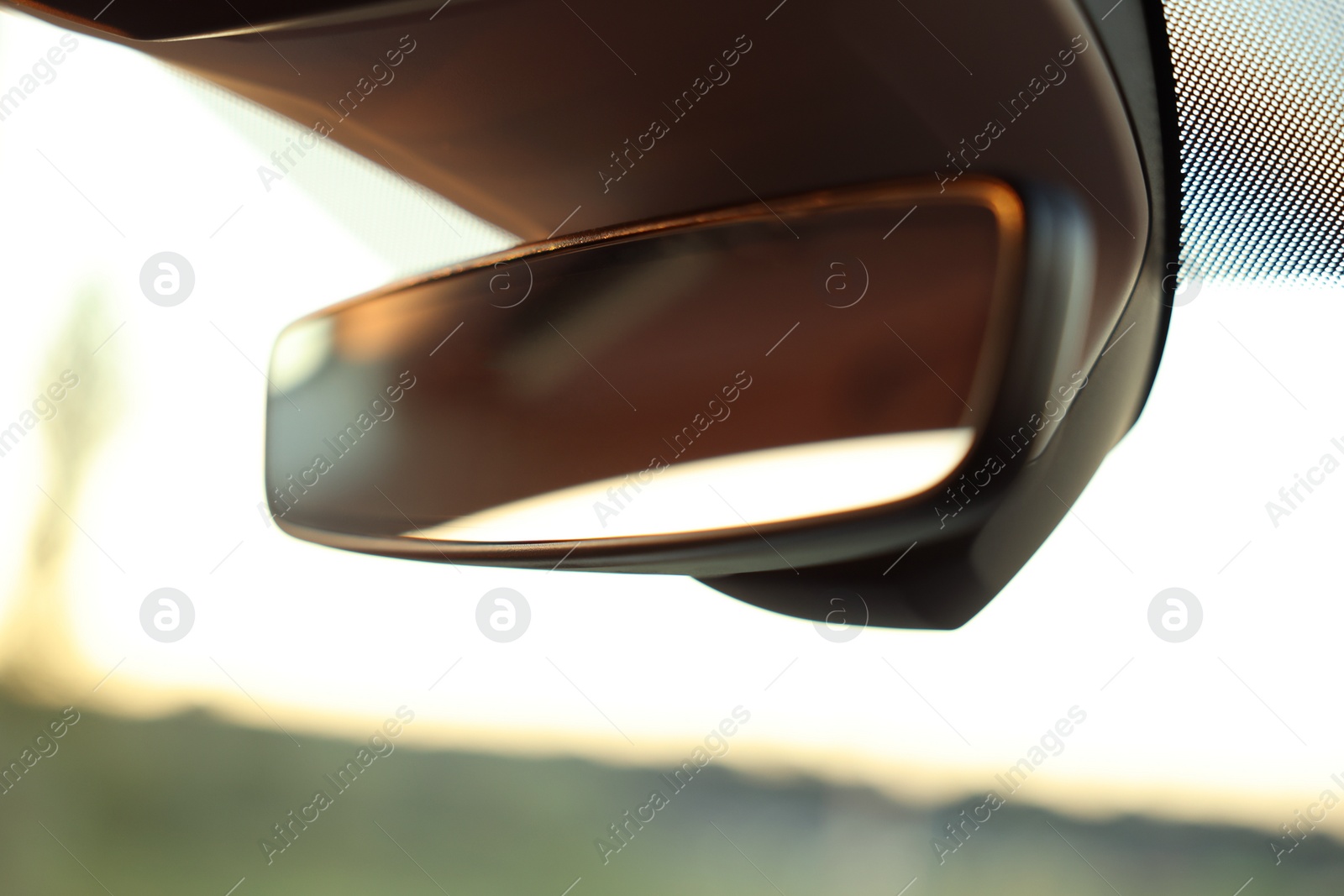 Photo of Clean rear view mirror in car, closeup