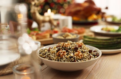 Photo of Festive dinner with traditional Christmas kutia served on table indoors. Slavic dish