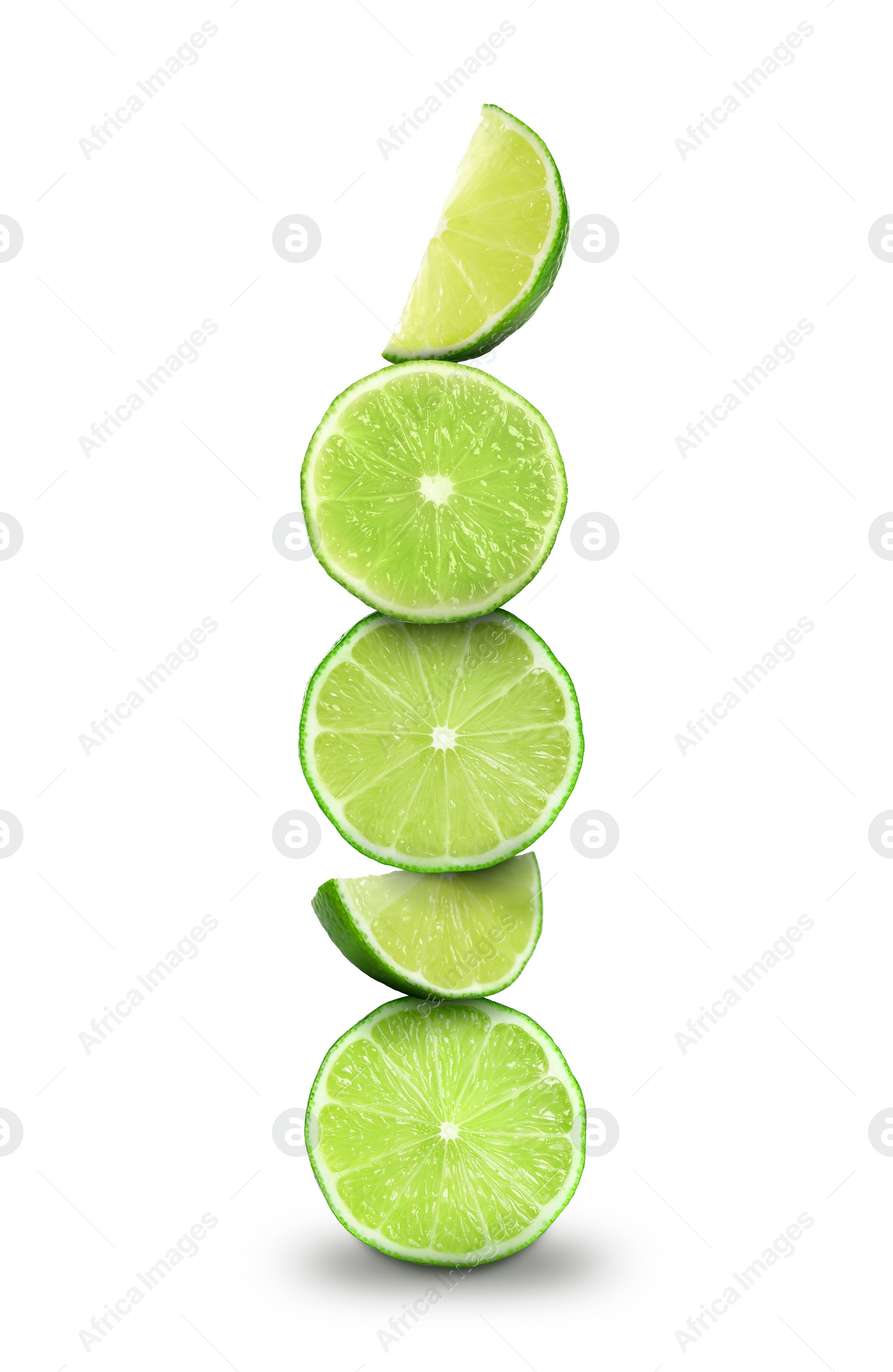 Image of Many stacked cut limes on white background