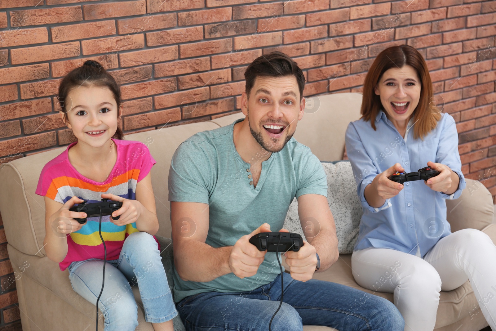 Photo of Happy family playing video games in living room