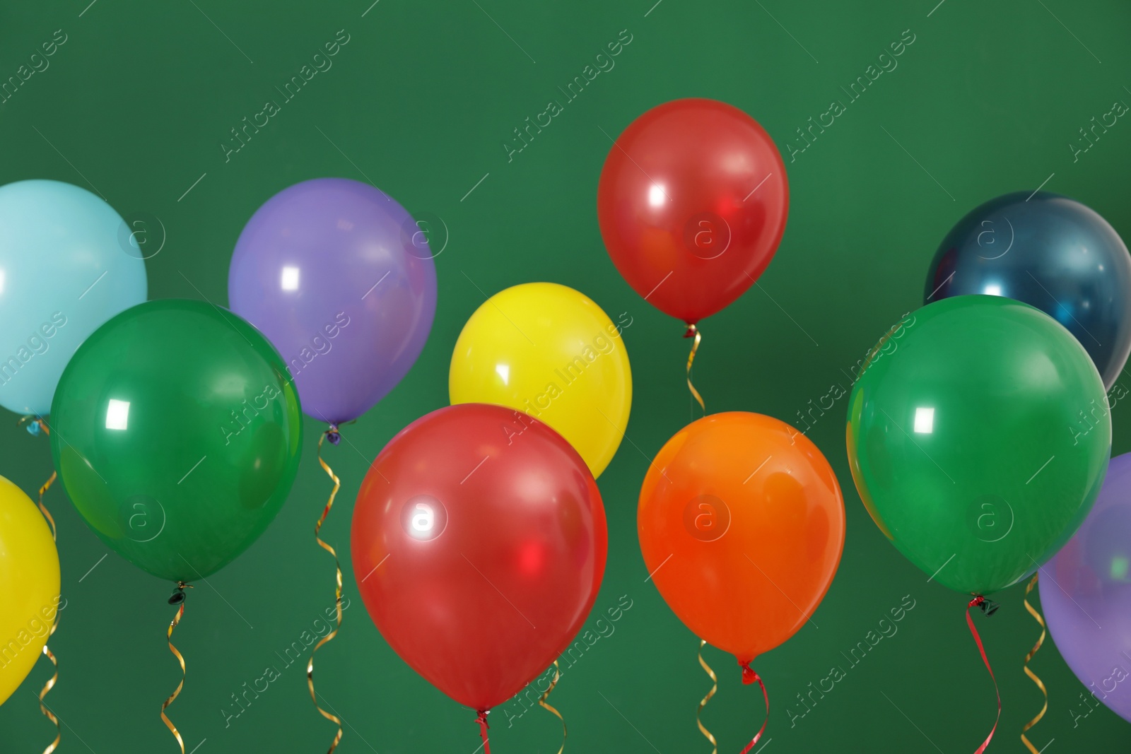 Photo of Bright balloons on color background. Celebration time