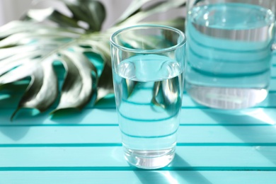 Photo of Glassware of fresh water on color table
