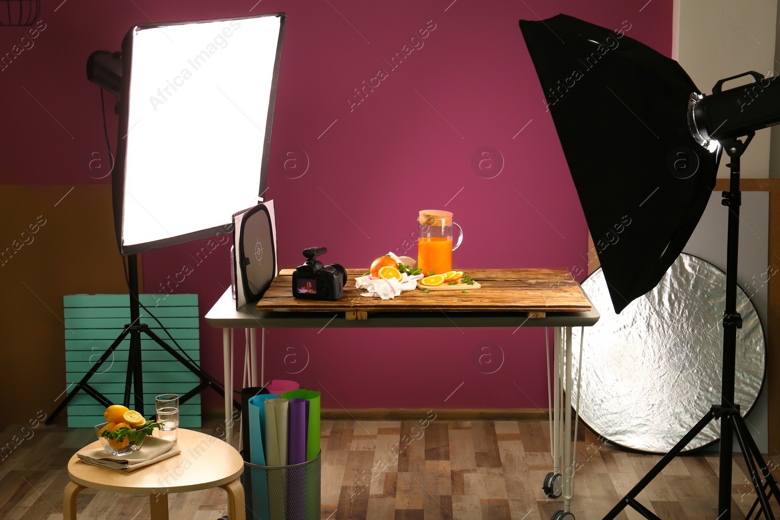 Photo of Cut oranges and jug with juice on table. Food photography