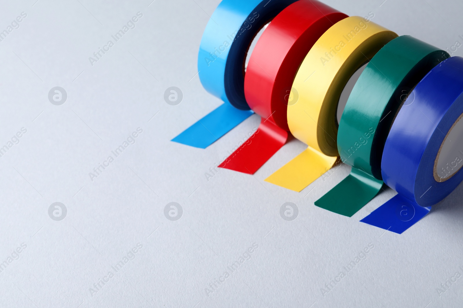 Photo of Colorful insulating tapes on white background. Space for text