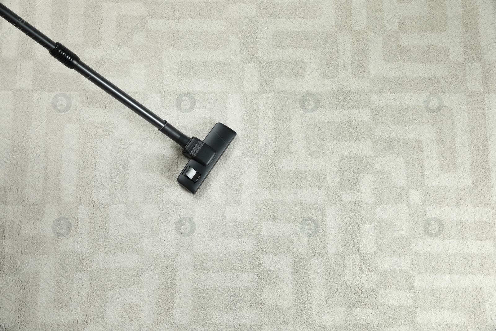 Photo of Removing dirt from white carpet with modern vacuum cleaner, top view. Space for text