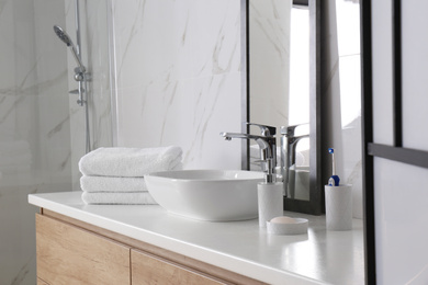 Modern mirror and vessel sink in stylish bathroom