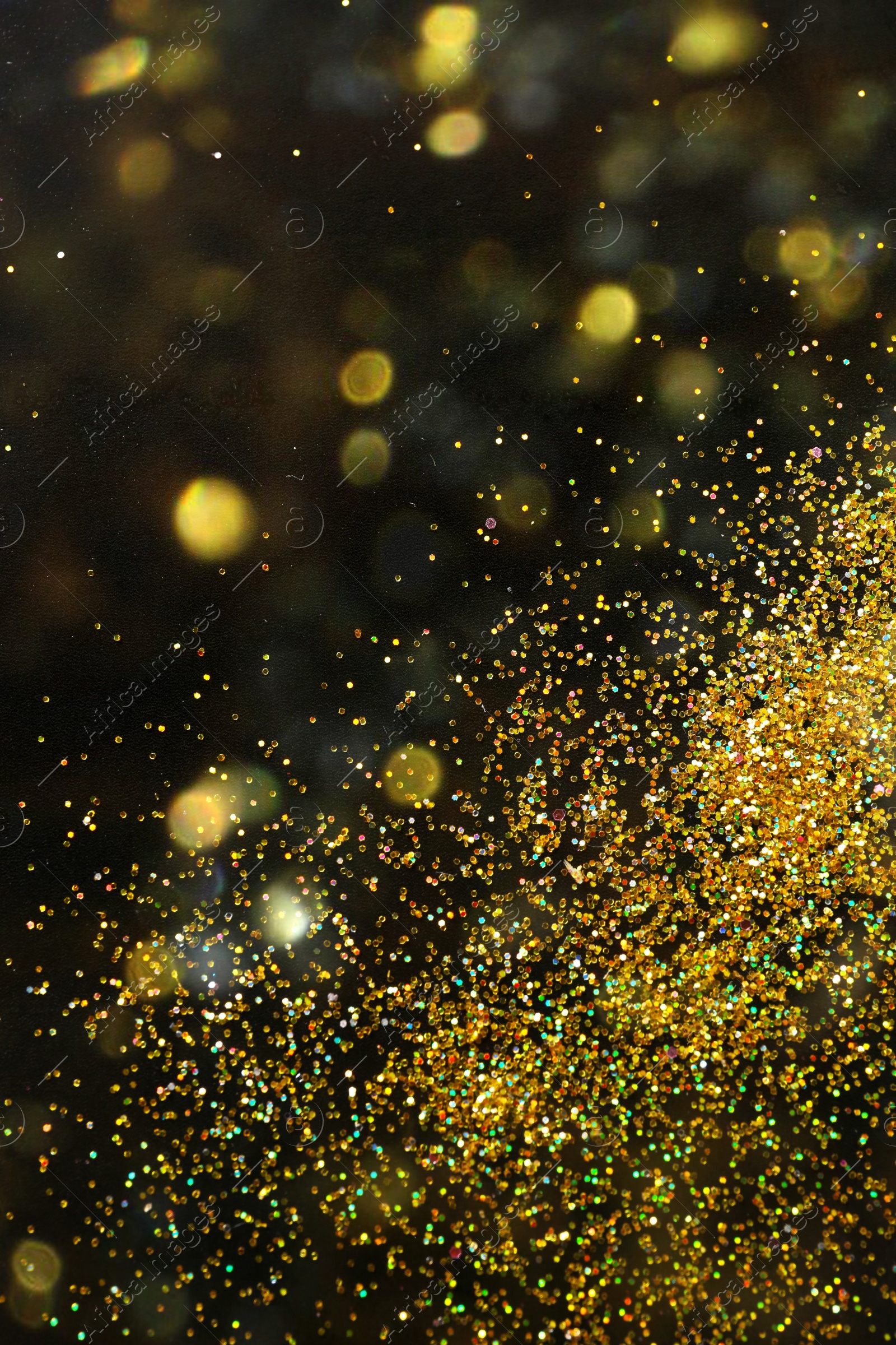 Photo of Shiny golden glitter on blurred background with bokeh effect. Space for text