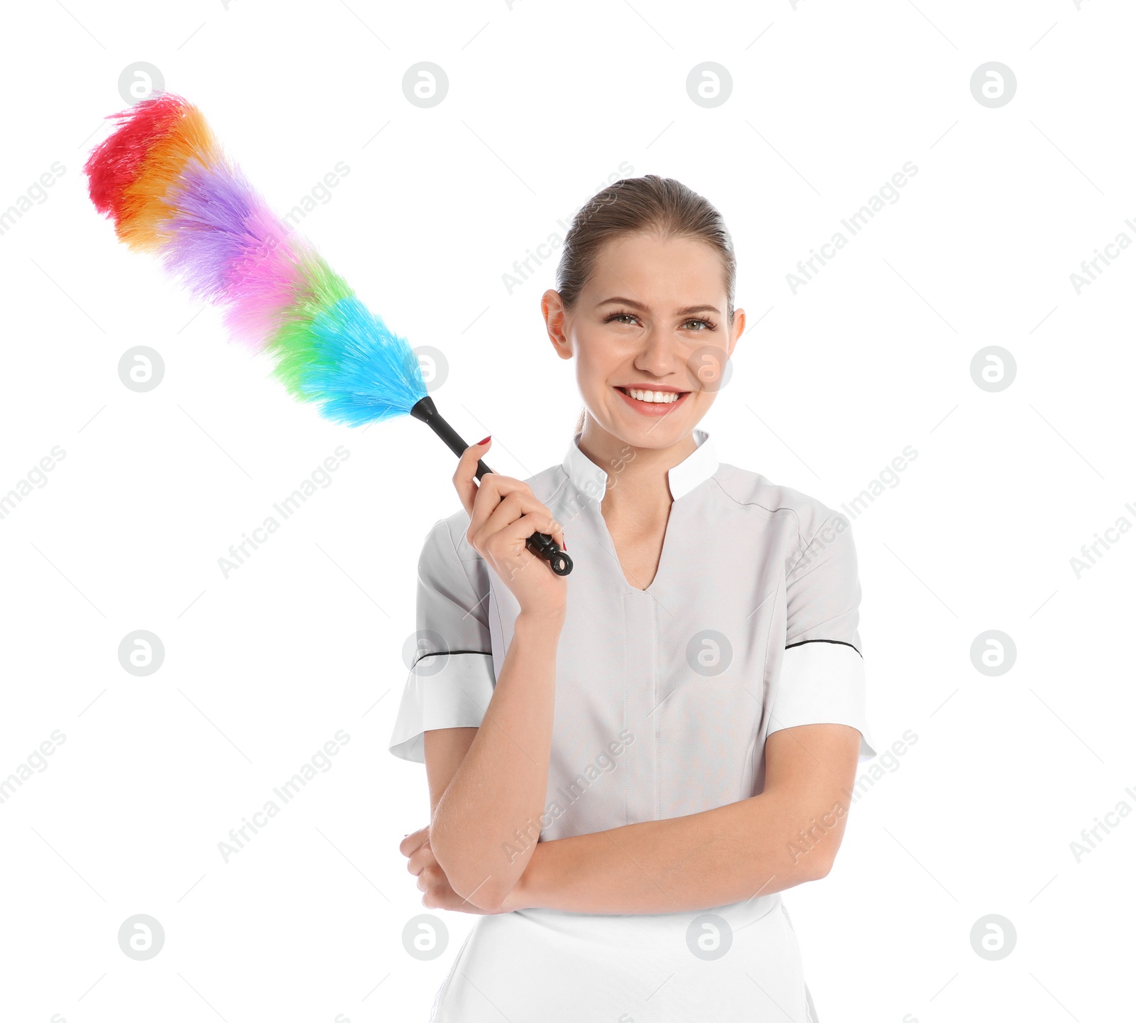 Photo of Young chambermaid with dusting brush on white background