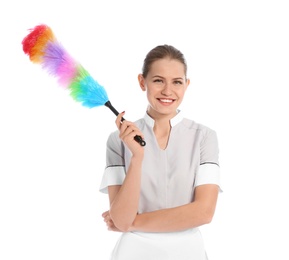 Young chambermaid with dusting brush on white background