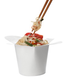 Photo of Eating vegetarian wok noodles with chopsticks from box isolated on white