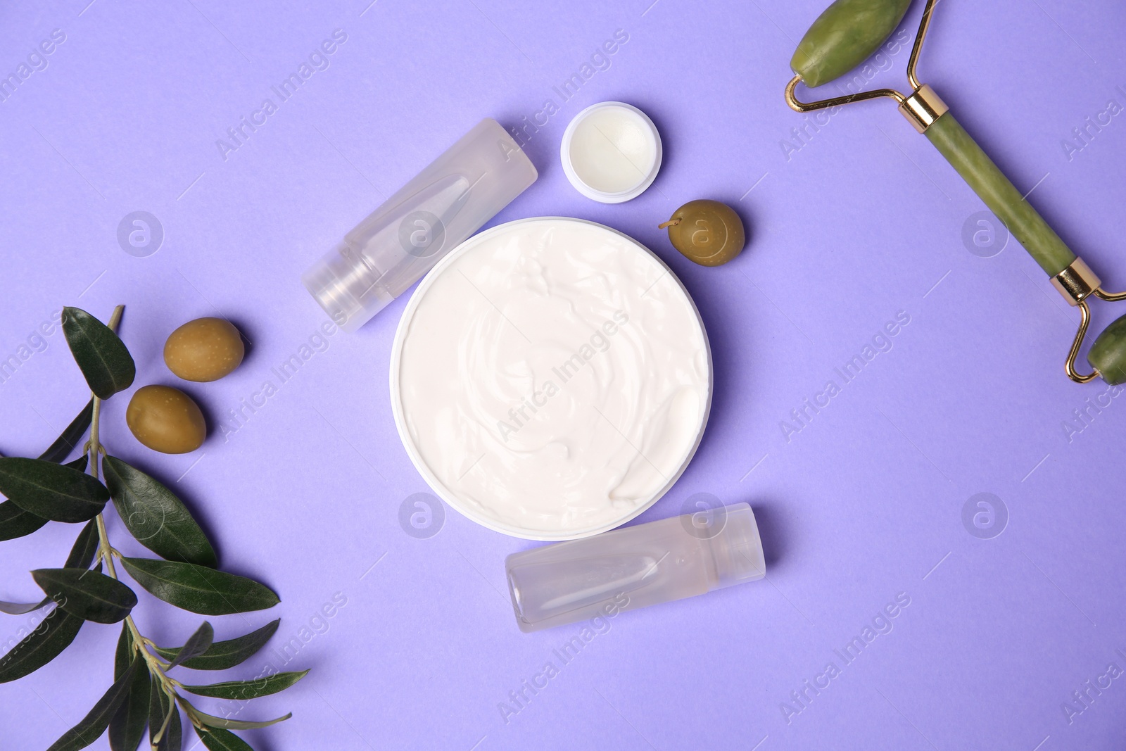 Photo of Different cosmetic products, face roller and olives on violet background, flat lay
