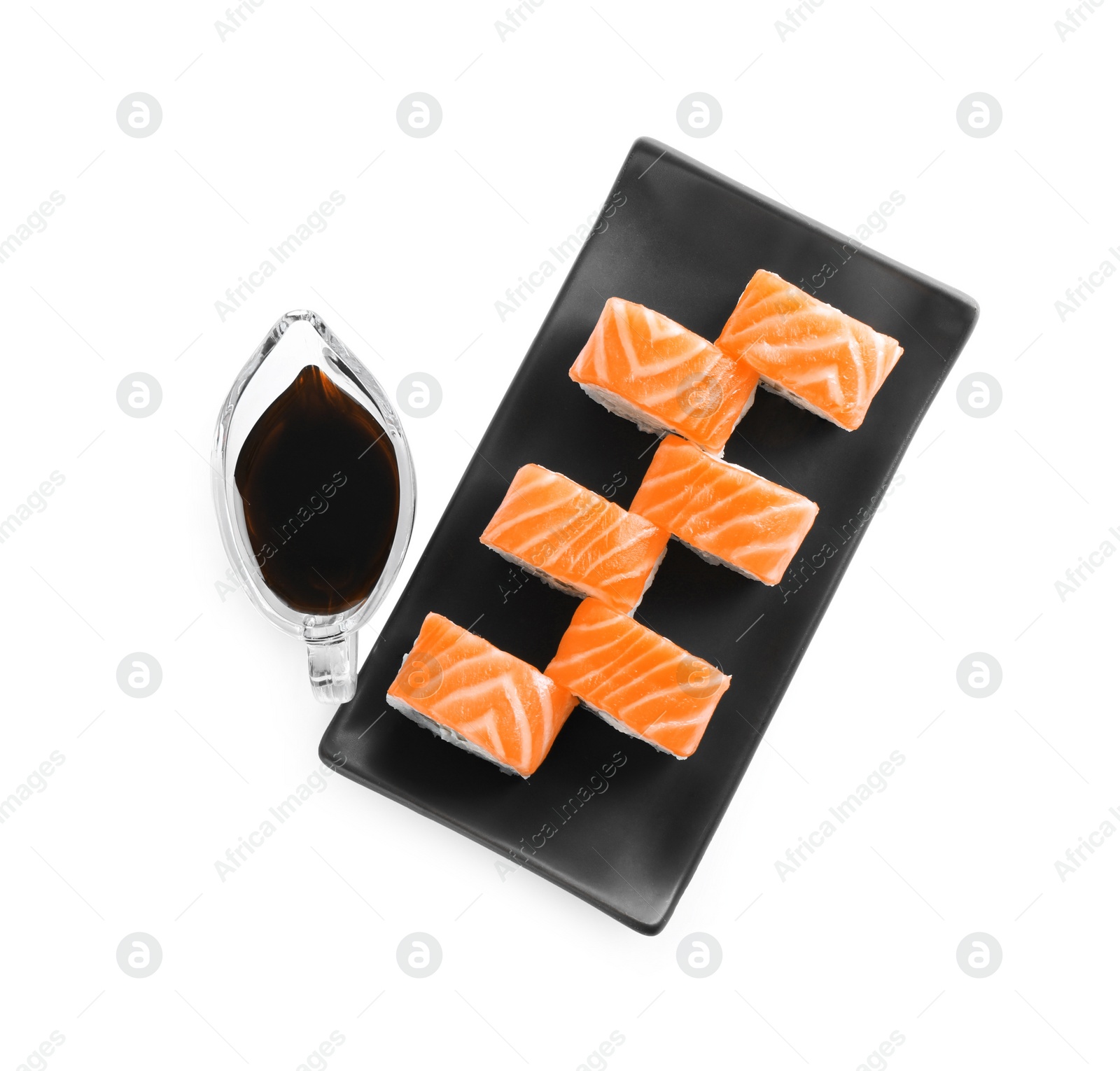 Photo of Tasty sushi rolls and soy sauce on white background, top view