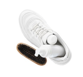 Stylish footwear with shoe care accessories on white background, top view