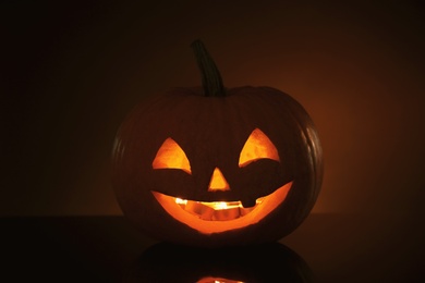 Photo of Halloween pumpkin head. Glowing jack lantern in dark
