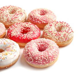 Photo of Delicious glazed doughnuts with sprinkles on light background