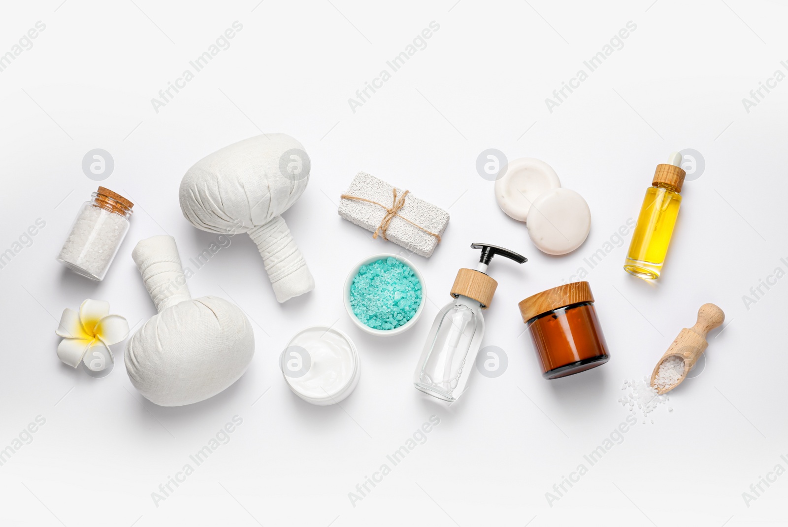 Photo of Beautiful spa composition with herbal massage bags and different care products on white background, flat lay