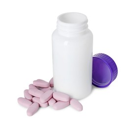 Photo of Bottle, lid and pile of vitamin pills isolated on white