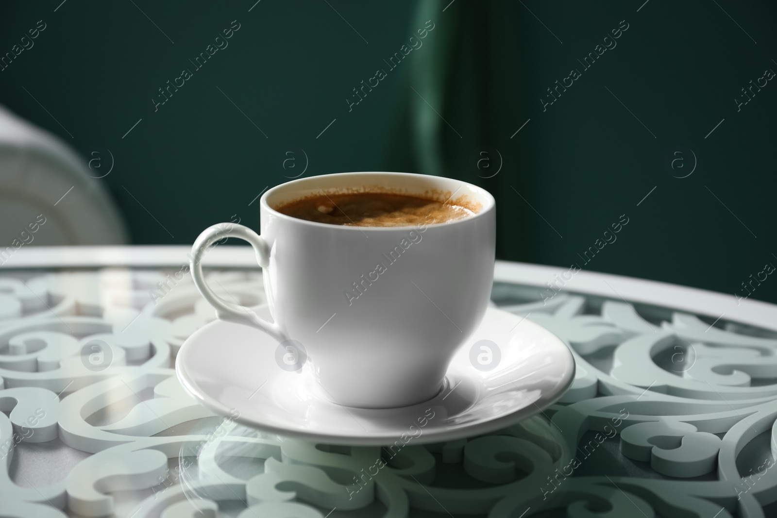 Photo of Cup of delicious aromatic coffee on table indoors, closeup