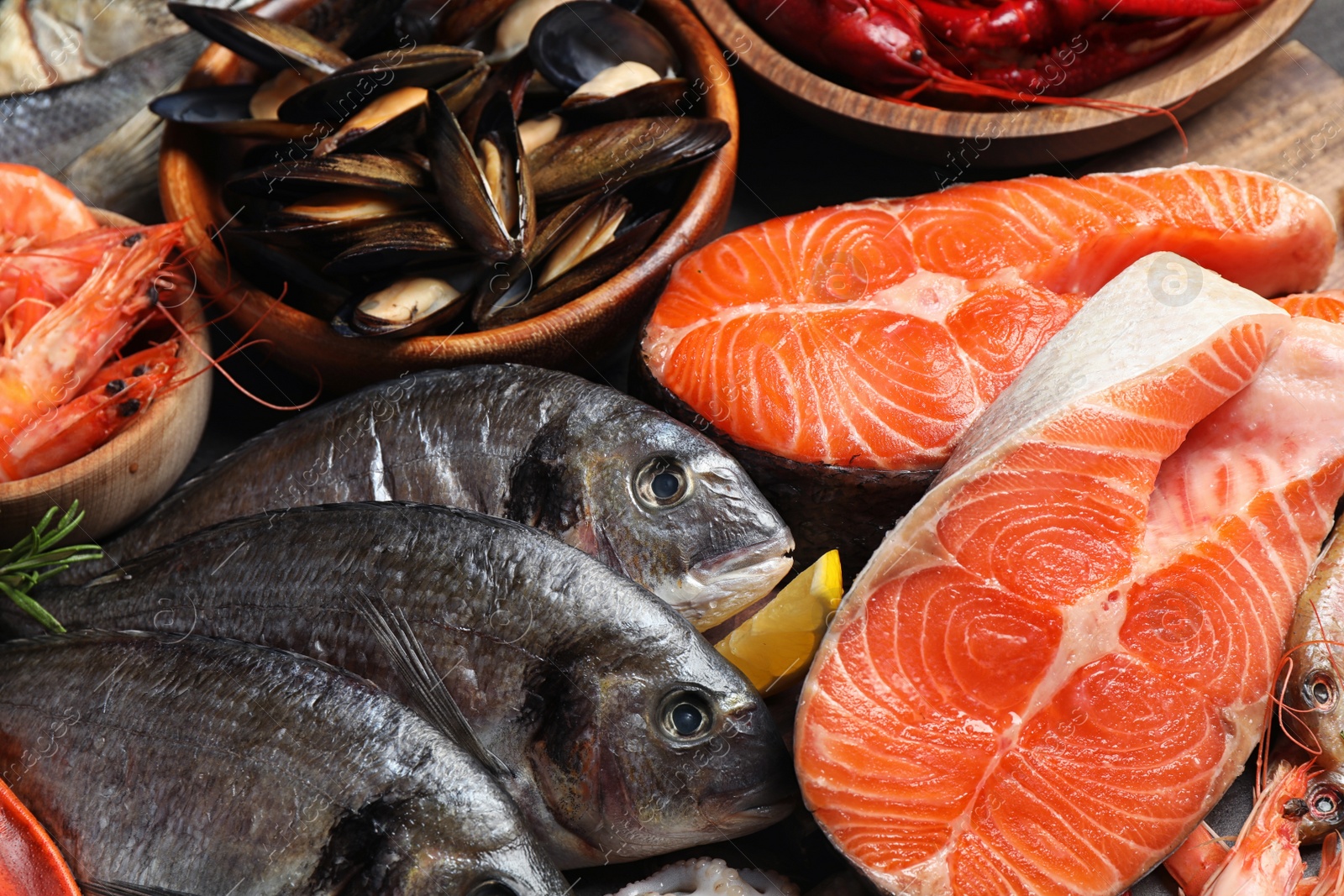 Photo of Fresh fish and different seafood on table