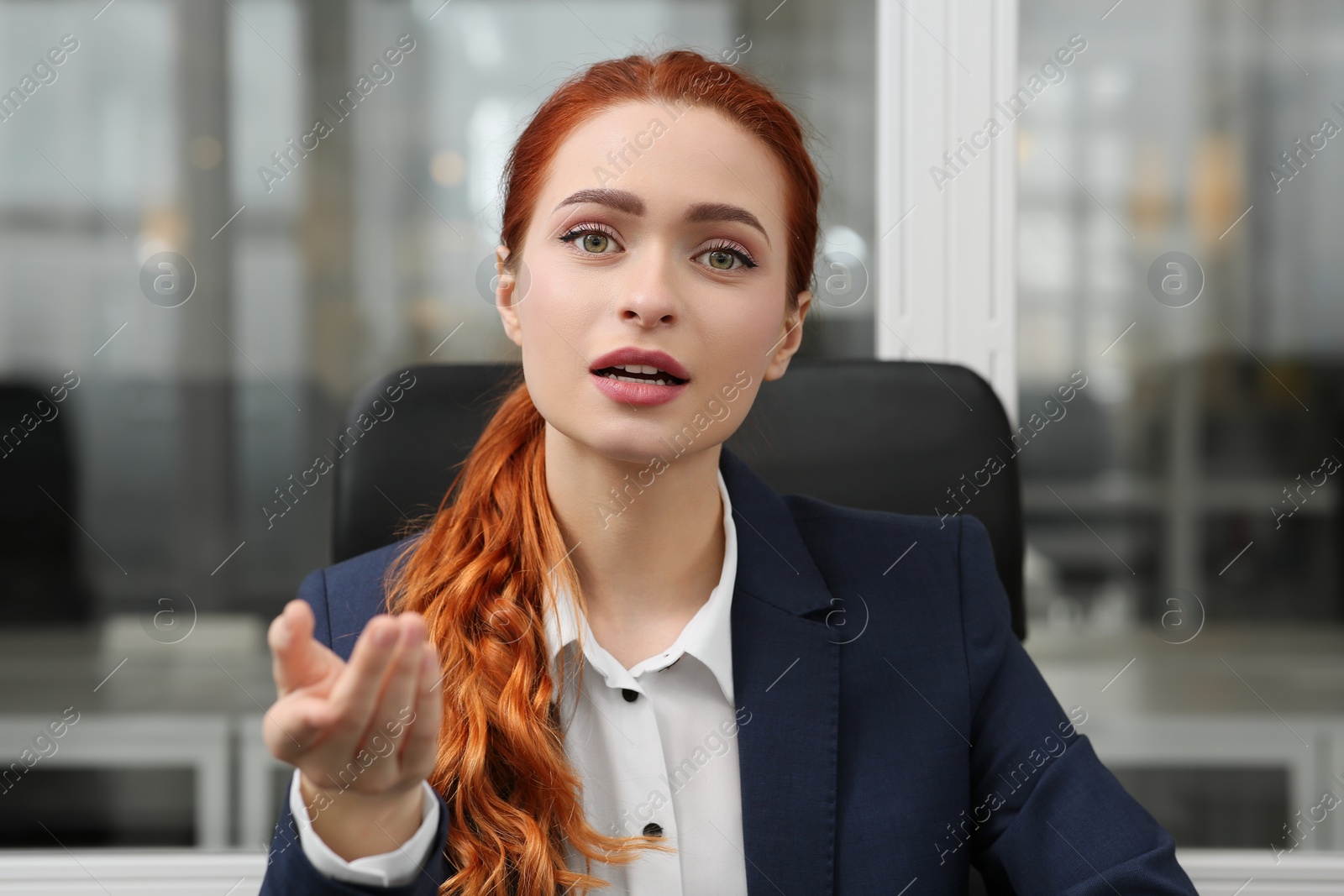 Photo of Woman having video call in office, view from web camera