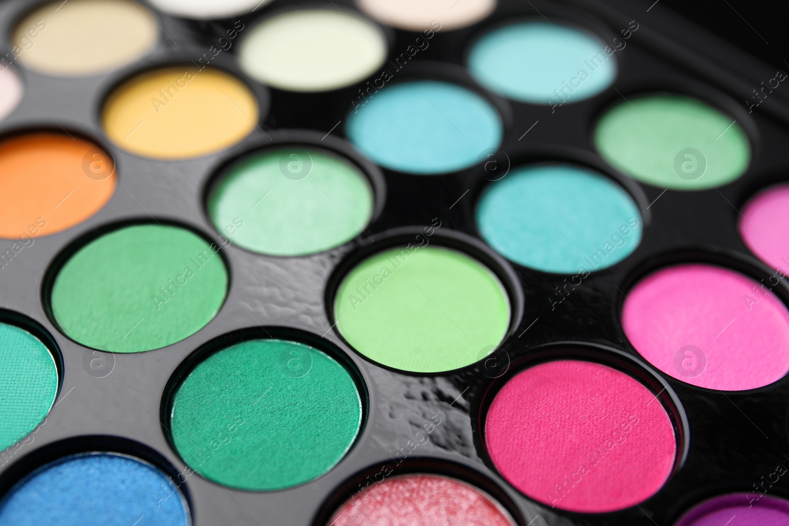 Photo of Beautiful eyeshadow palette as background, closeup. Professional cosmetic product