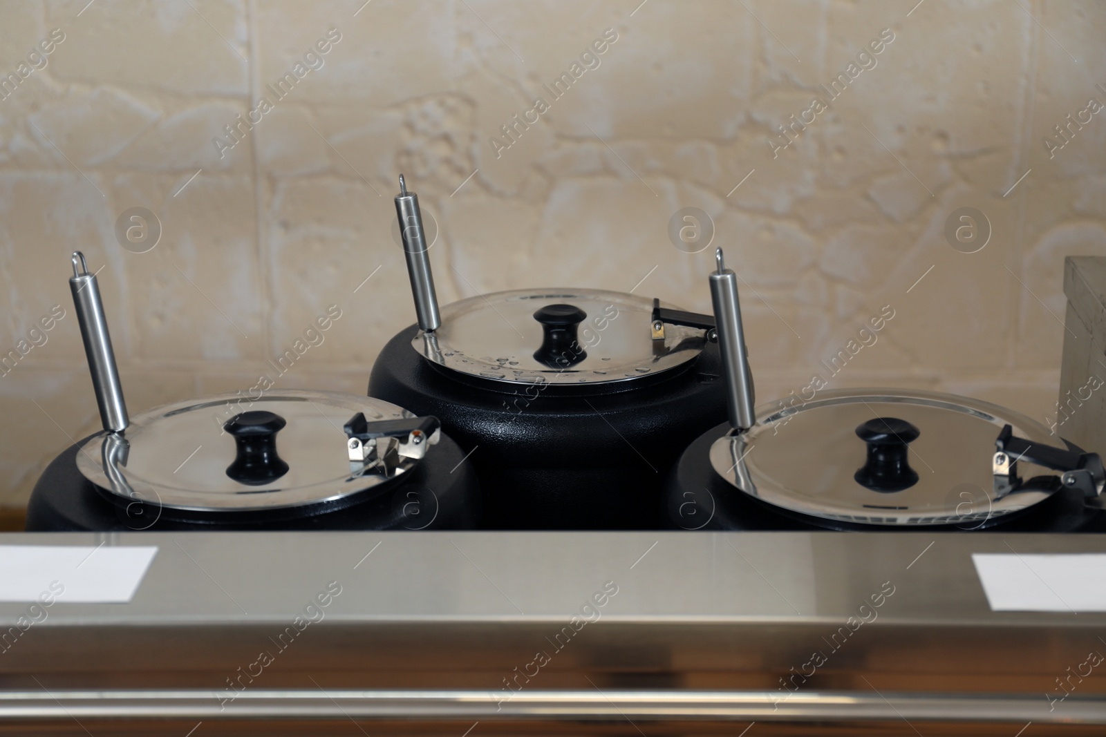 Photo of Cooking pots with tasty food in school canteen