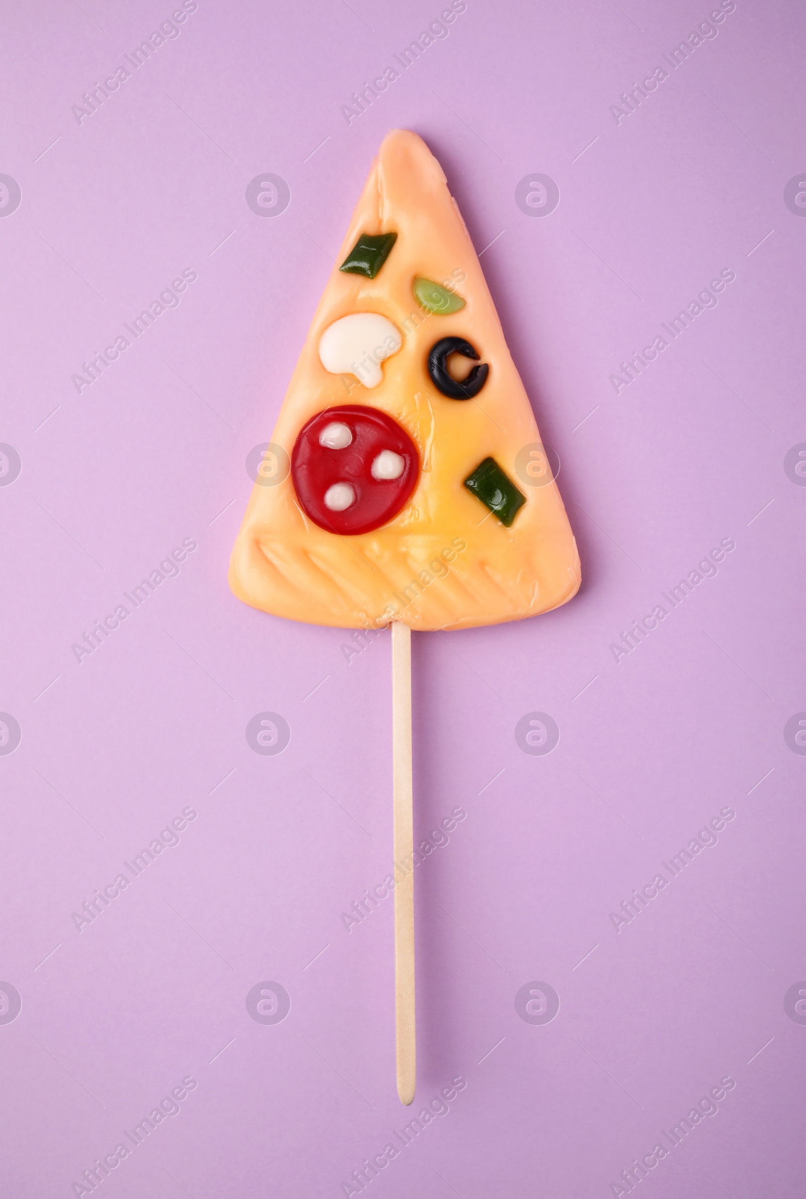 Photo of Pizza shaped lollipop on violet background, top view