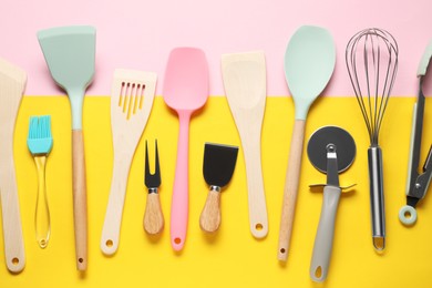 Photo of Different spatulas and other kitchen utensils on color background, flat lay