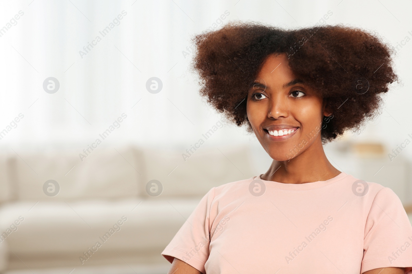 Photo of Portrait of smiling African American woman at home. Space for text