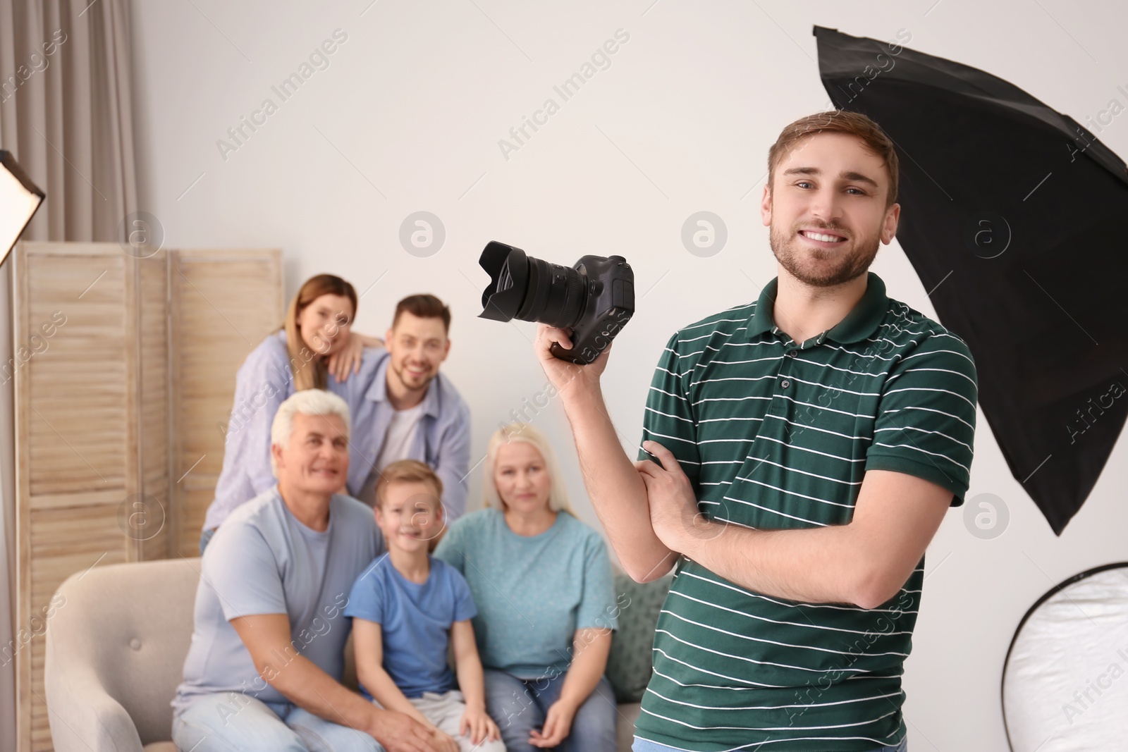 Photo of Professional photographer with camera and family in studio