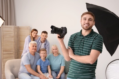 Professional photographer with camera and family in studio