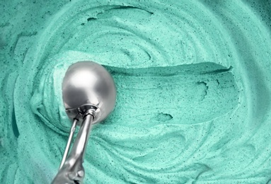 Photo of Delicious vegan spirulina ice cream and scoop, top view