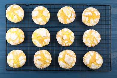 Photo of Tasty homemade lemon cookies on blue wooden table, top view