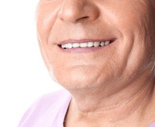 Photo of Mature man with healthy teeth on white background, closeup