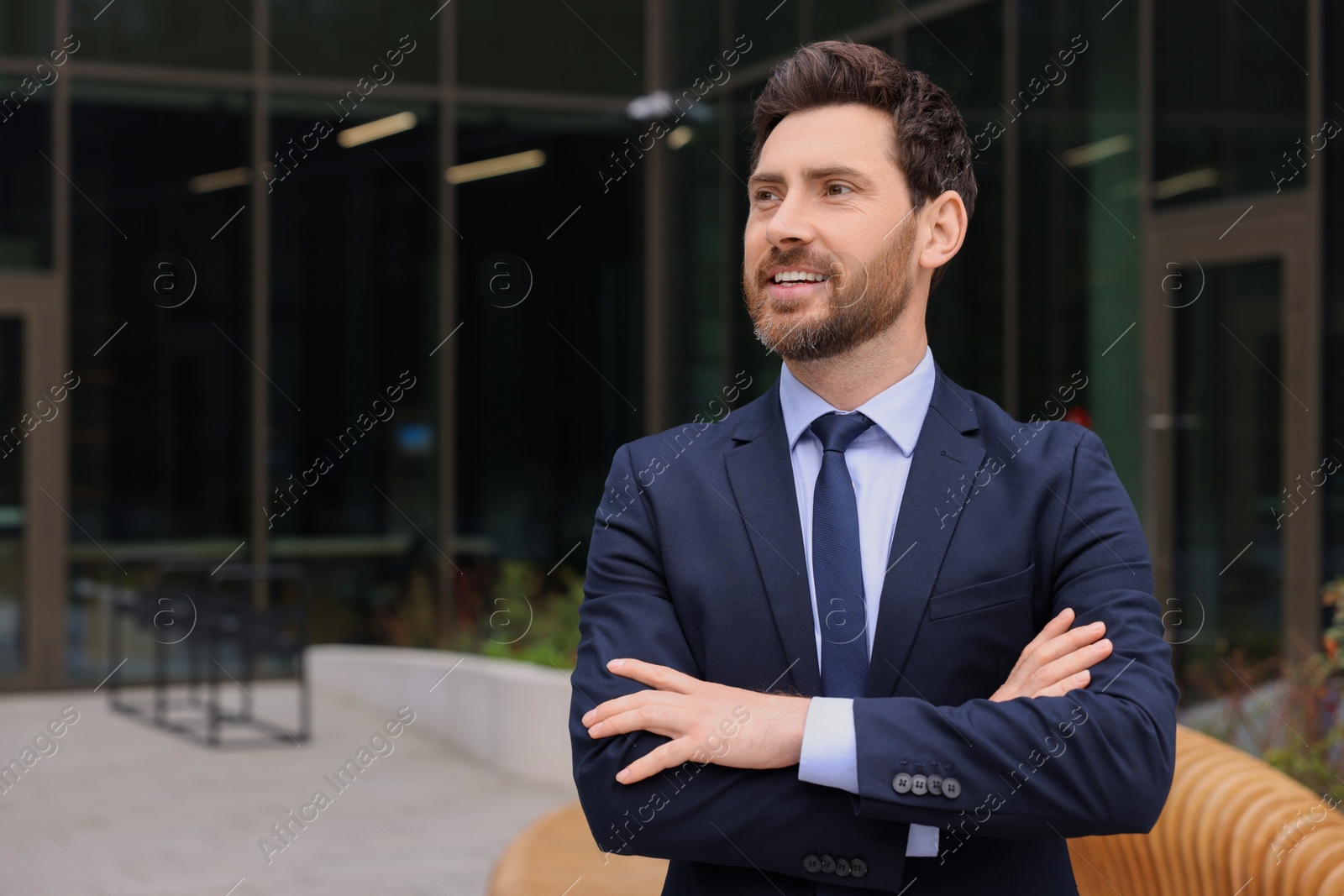 Photo of Male real estate agent outdoors. Space for text